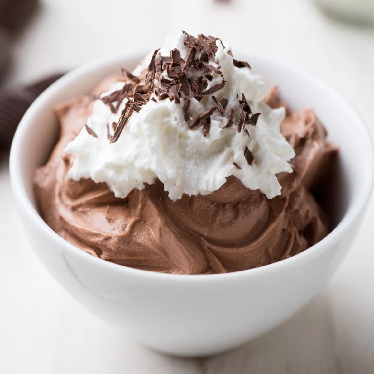 Ready-to-serve Chocolate Mousse in dessert glasses, each topped with a fresh vanilla whipped cream dollop and cocoa dusting.