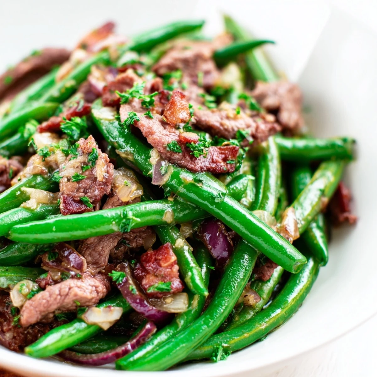 Hearty skillet of Lemon Garlic Green Beans with Bacon Beef served alongside fluffy white rice for a complete meal.