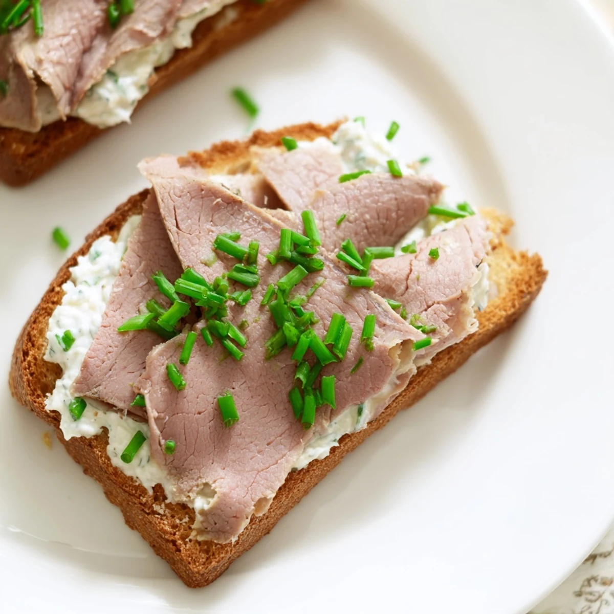 Easy Beef Toast Points with Spread served on a platter, featuring crisp bread, rich meat, and a tangy, peppery finish.
