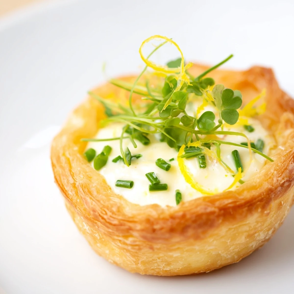 Golden Lemon Appetizer Tartlets with a crisp, buttery puff pastry shell and a vibrant, tangy lemon cream filling.