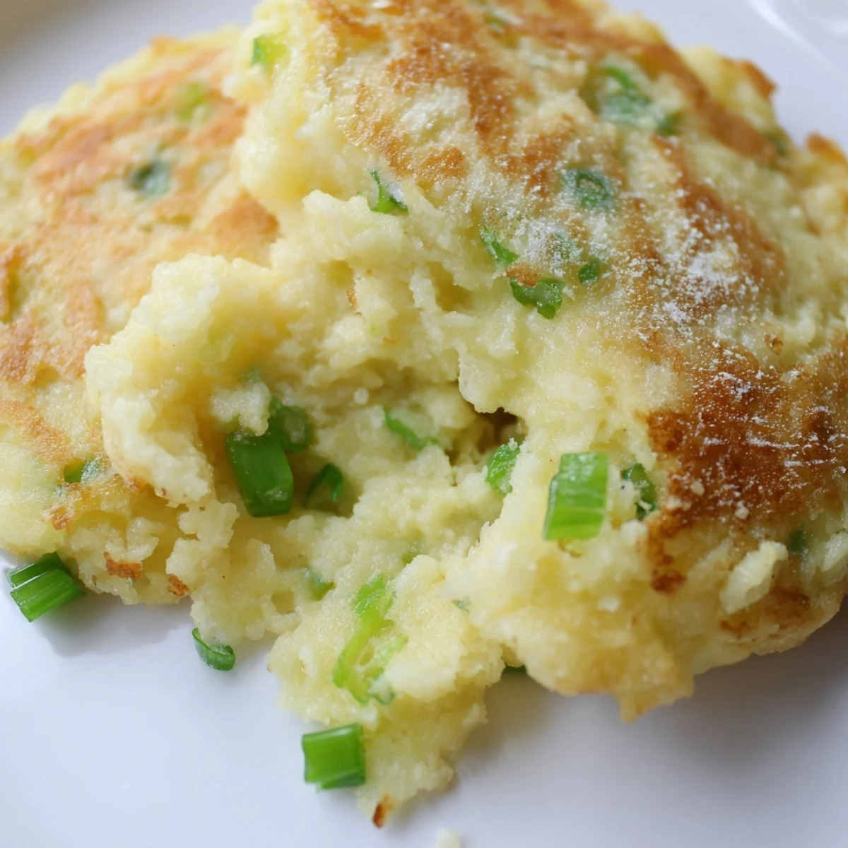 Freshly fried Irish Potato Cakes with Scallions, golden and crisp on the edges with bright green onion flecks throughout.