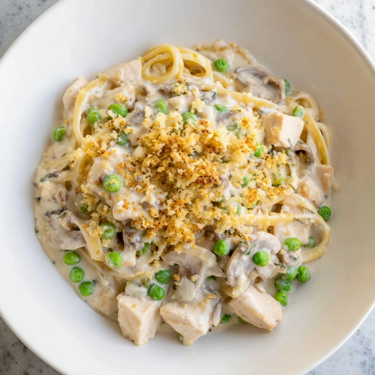 Savory Turkey Tetrazzini casserole on a rustic plate with a side salad.