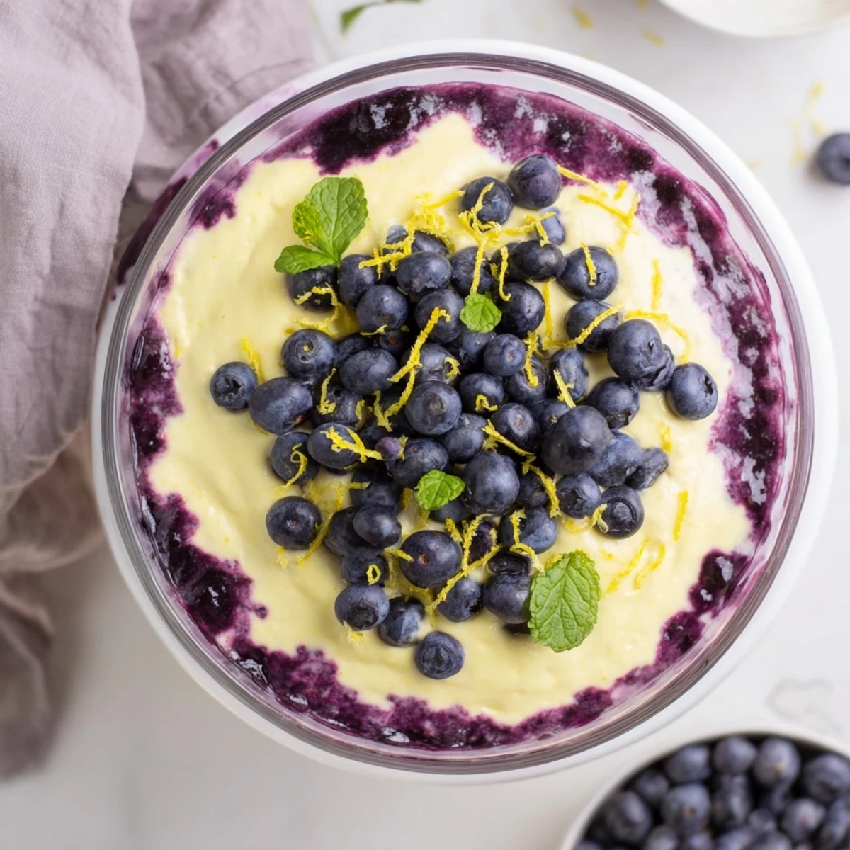 Served chilled in a tall glass, this airy mousse combines tangy lemon flavor and sweet blueberry compote for a refreshing finish.