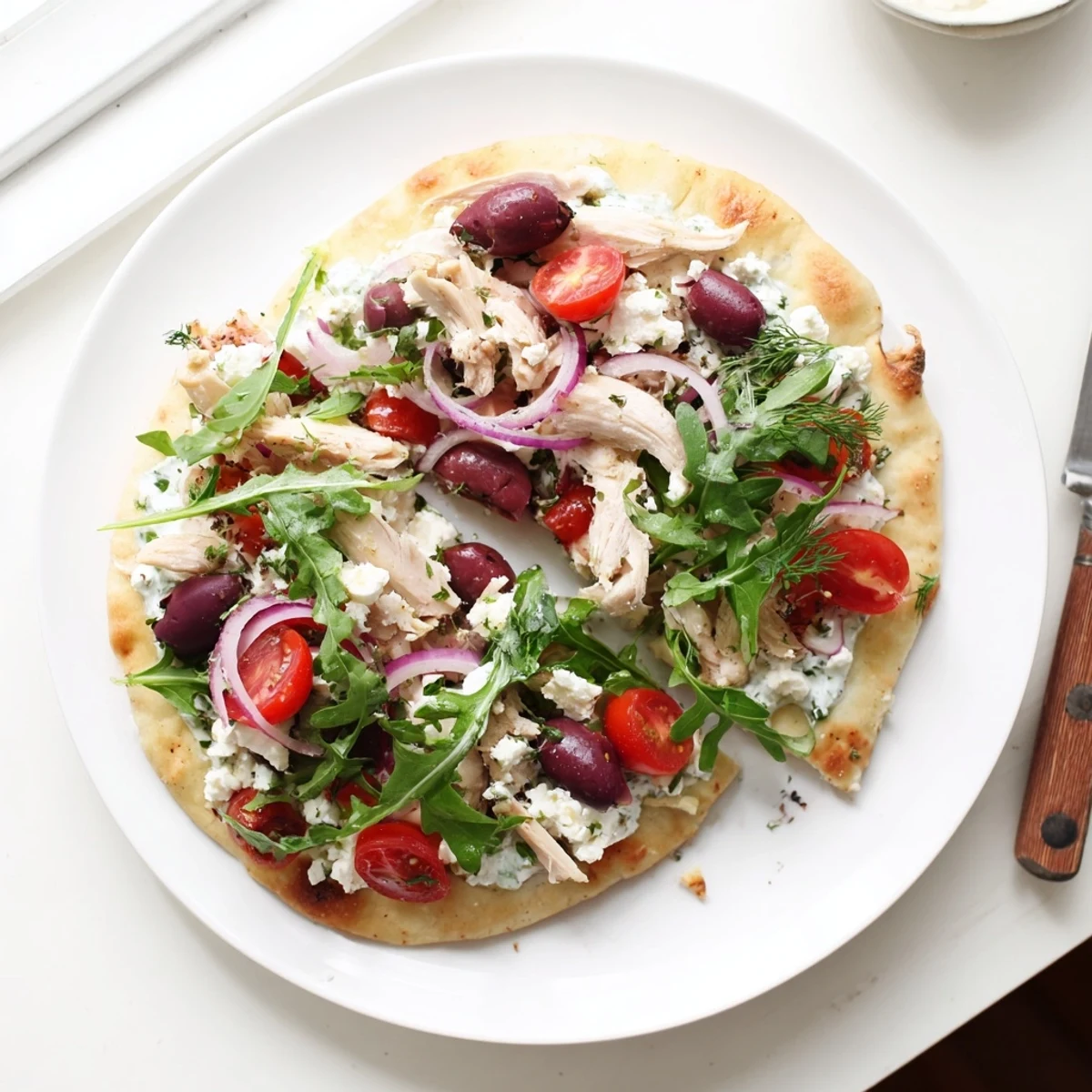 Golden, crispy flatbread loaded with juicy lemon-herb chicken, creamy feta, and fresh arugula.