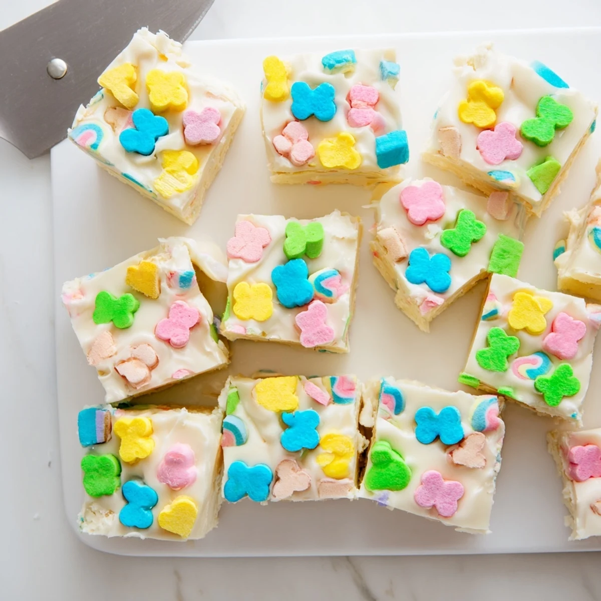 Rich and smooth Easy Lucky Charms Fudge squares studded with bright pink and green marshmallow shapes