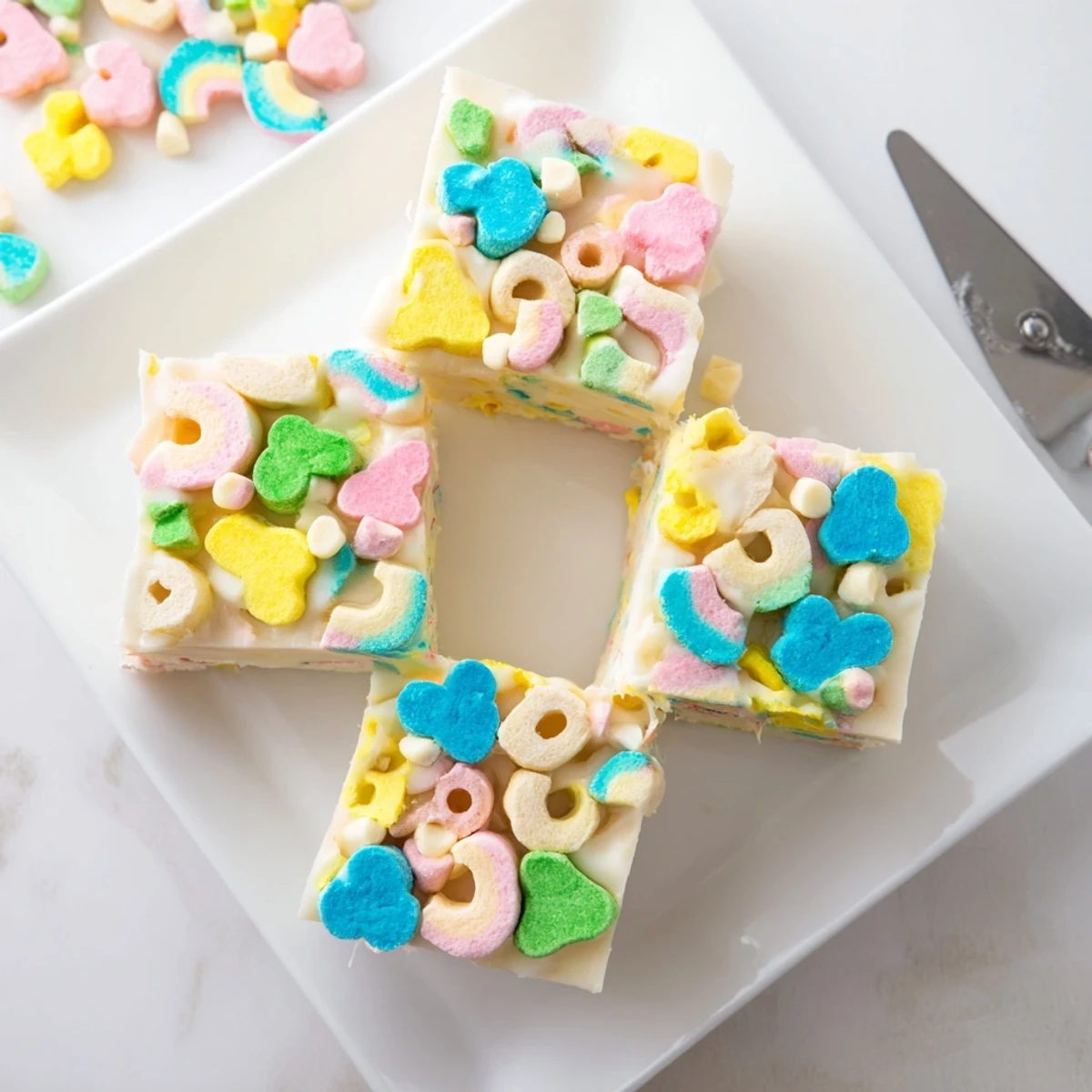 Creamy white chocolate Easy Lucky Charms Fudge topped with colorful marshmallow bits in a square baking pan