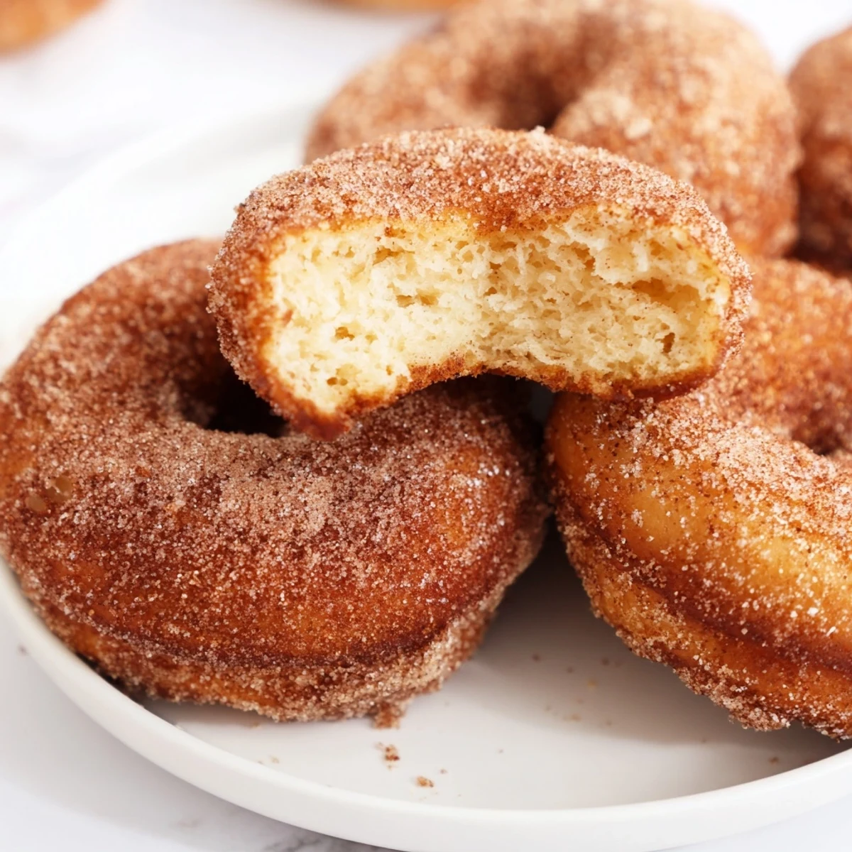 Fried pumpkin spice biscuit donuts dusted with spiced sugar, perfect cozy fall dessert treat