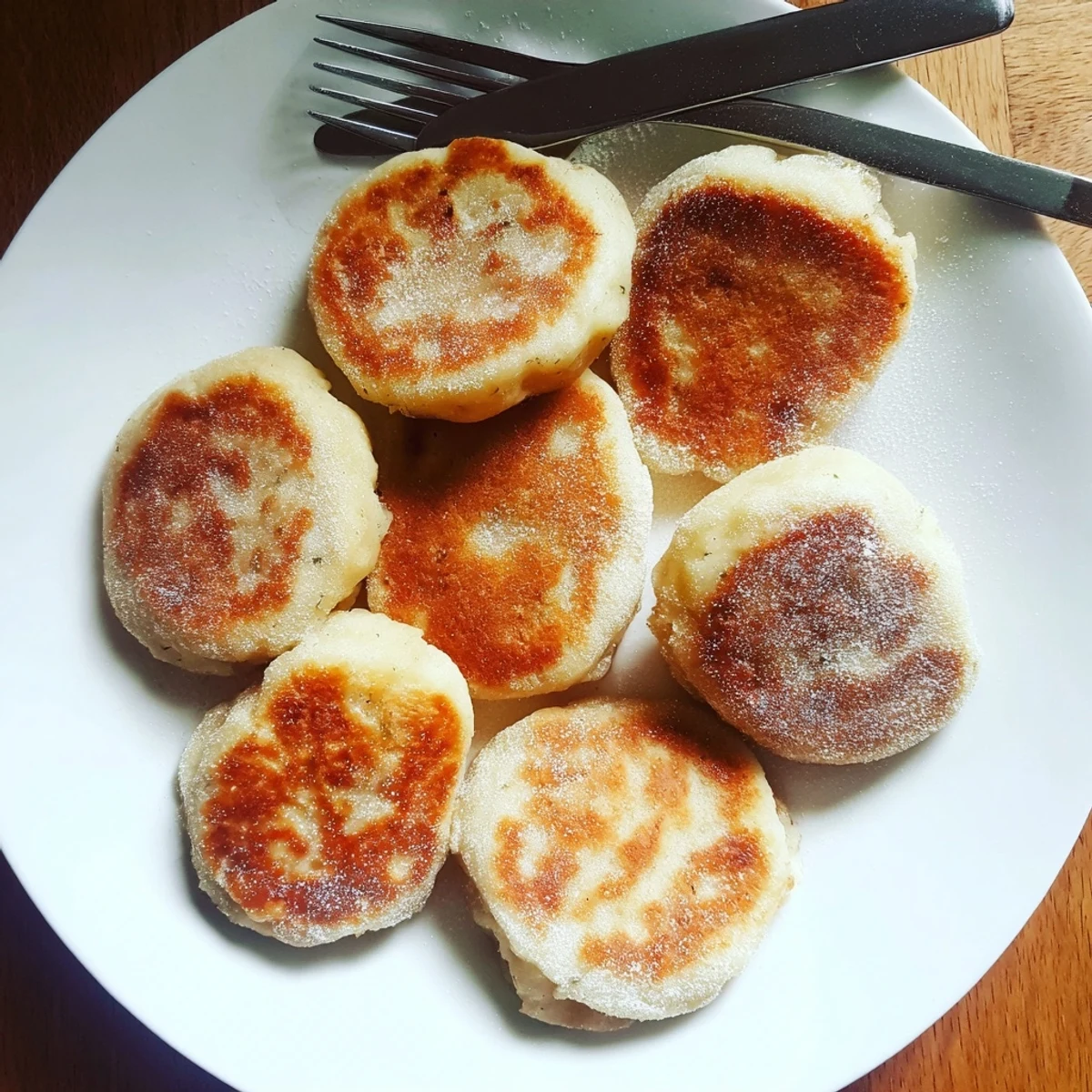 Traditional Irish potato cakes sizzling in a cast iron skillet with golden crusts