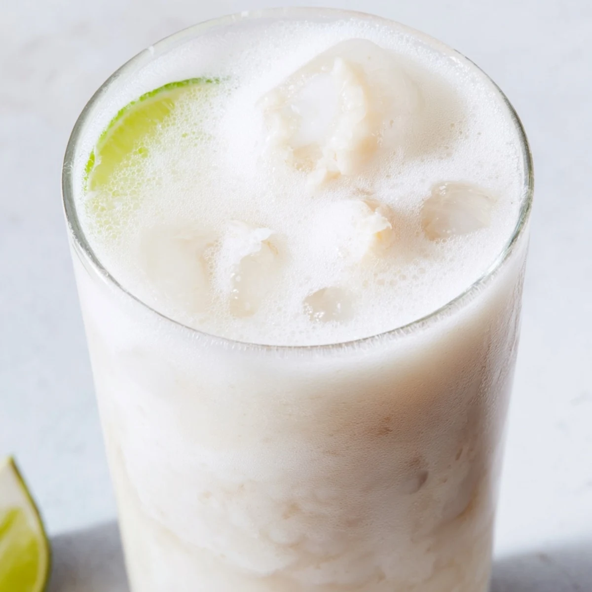 Creamy coconut lychee iced drink blended to frothy perfection topped with lime wheel and fresh mint sprig