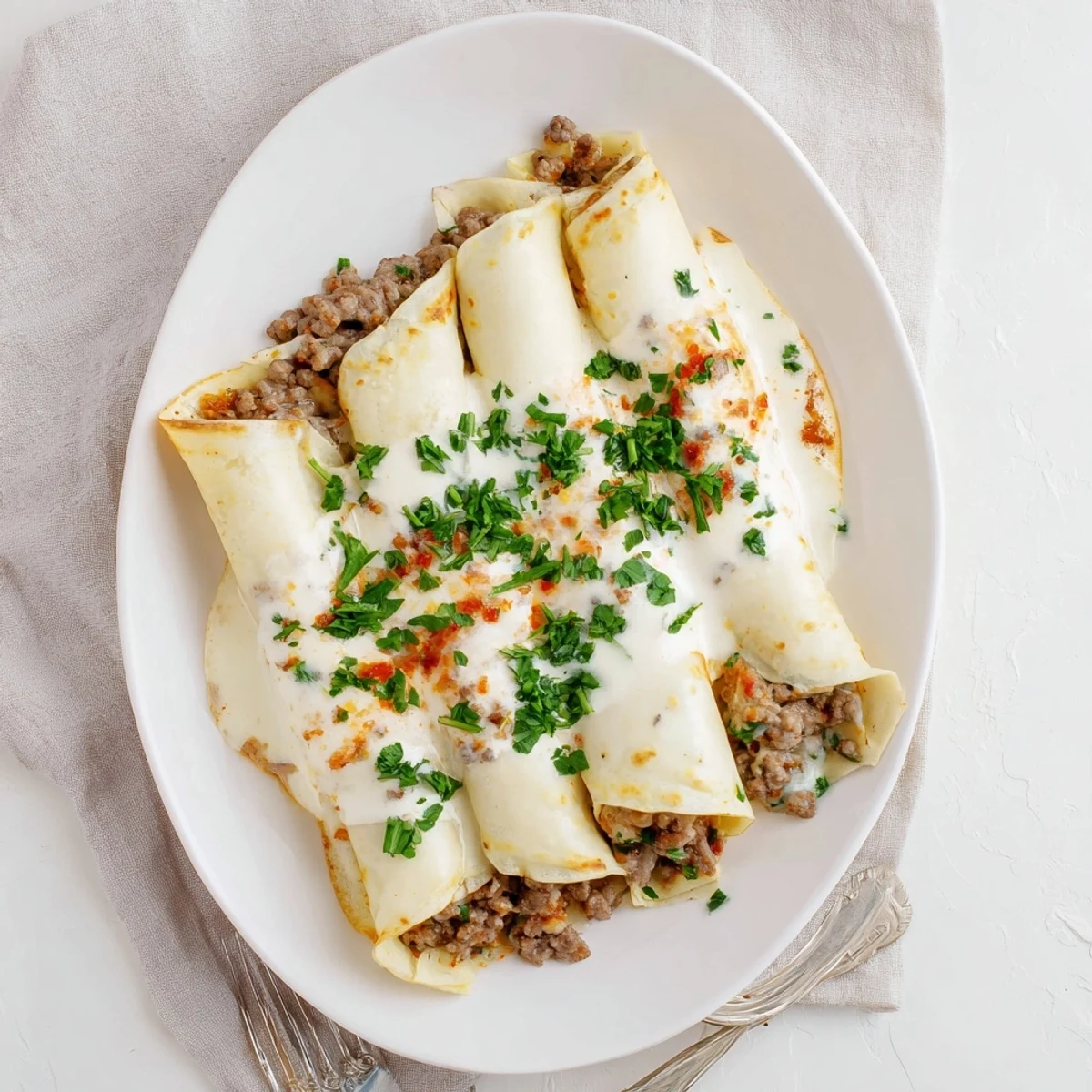 Golden Hortobágyi palacsinta filled with savory paprika meat ragout and creamy sour cream sauce