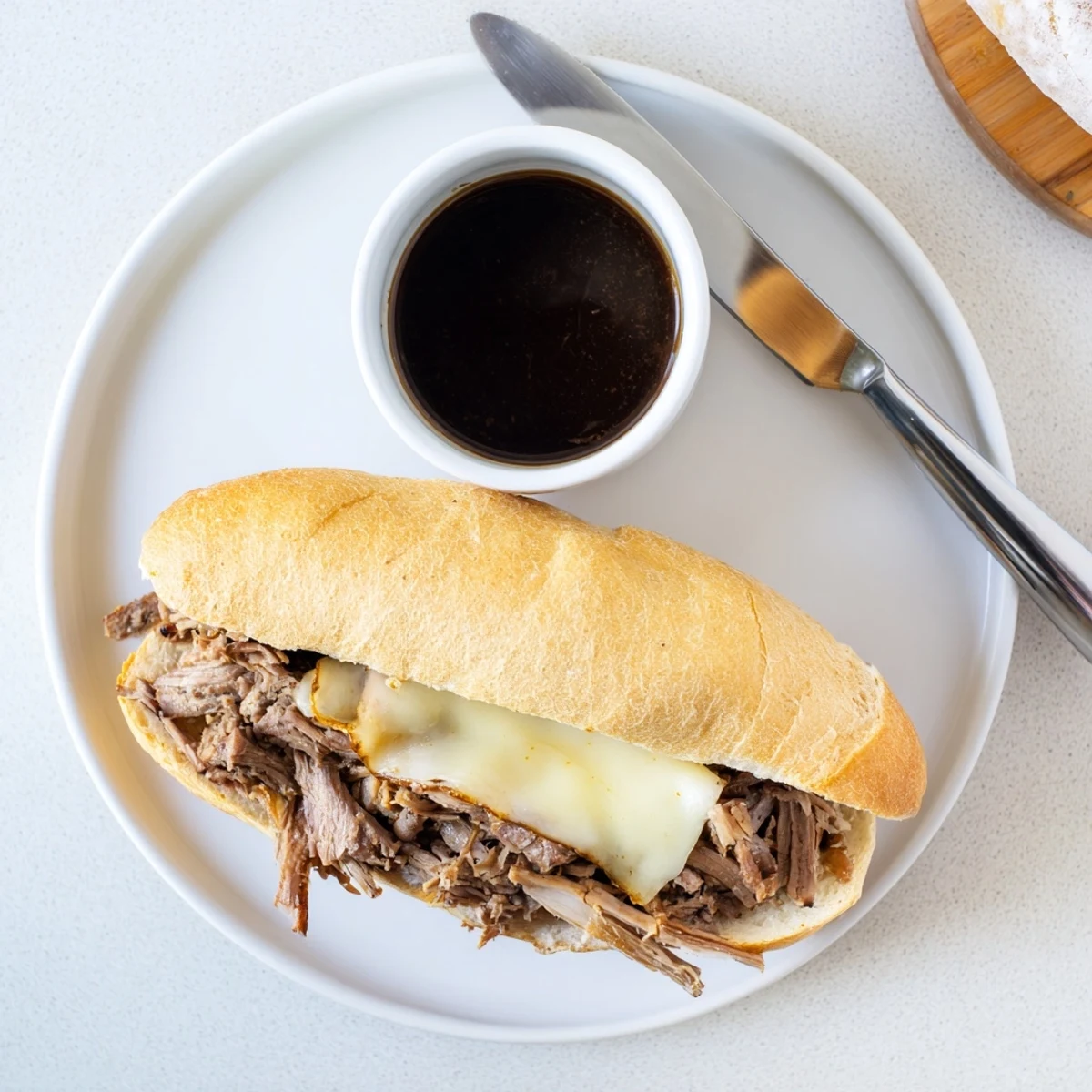 Crockpot French Dip Sandwiches with tender shredded beef, melted provolone cheese, and golden toasted hoagie rolls