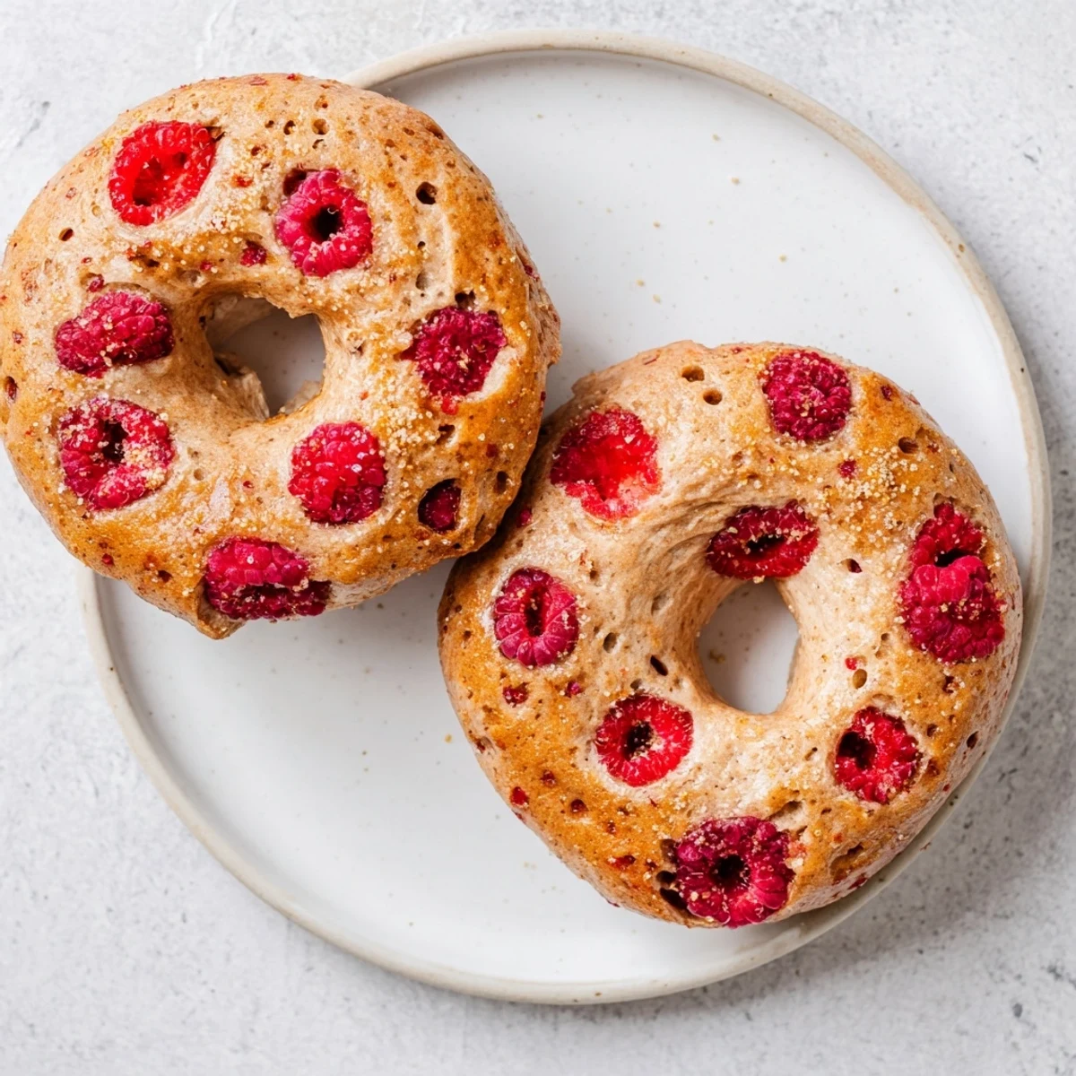 Freshly baked raspberry sourdough bagels with juicy fruit pockets and golden crust