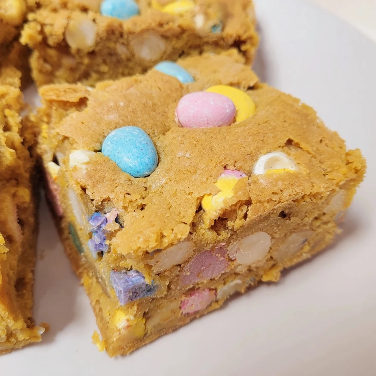 Chewy Mini Cadbury Easter Egg blondies with colorful candy pieces studded throughout golden bars