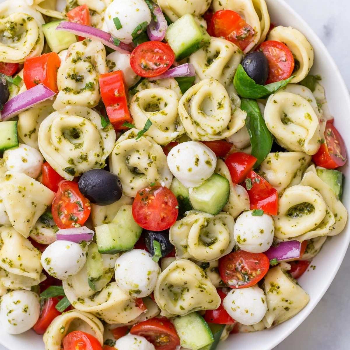 Cheese tortellini pasta salad tossed with crisp vegetables and zesty Italian dressing