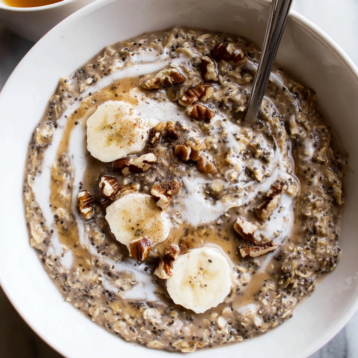 Brown Sugar Coffee Overnight Oats in a jar topped with banana and toasted pecans