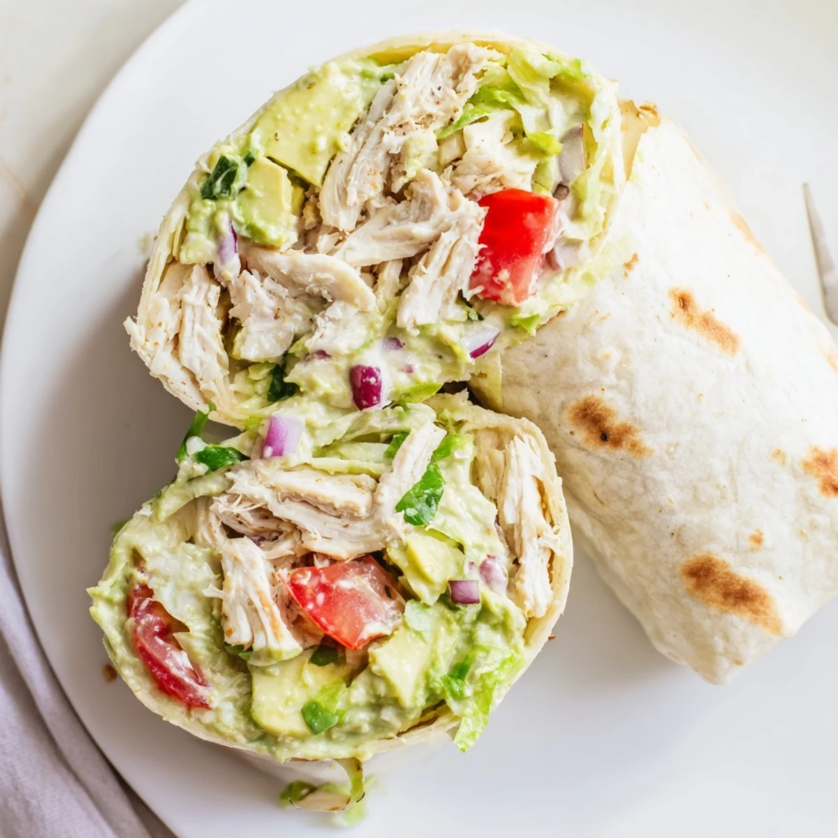 Warm Chicken Avocado Ranch Burritos on skillet, golden brown exterior, zesty drizzle  