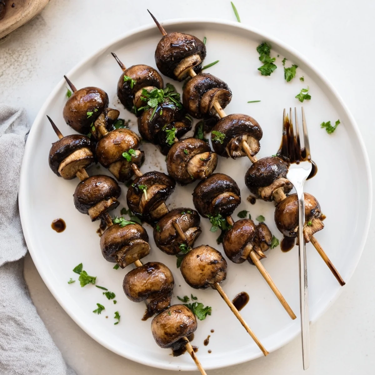 Plated Balsamic Garlic Grilled Mushroom Skewers garnished with parsley, ready to serve.