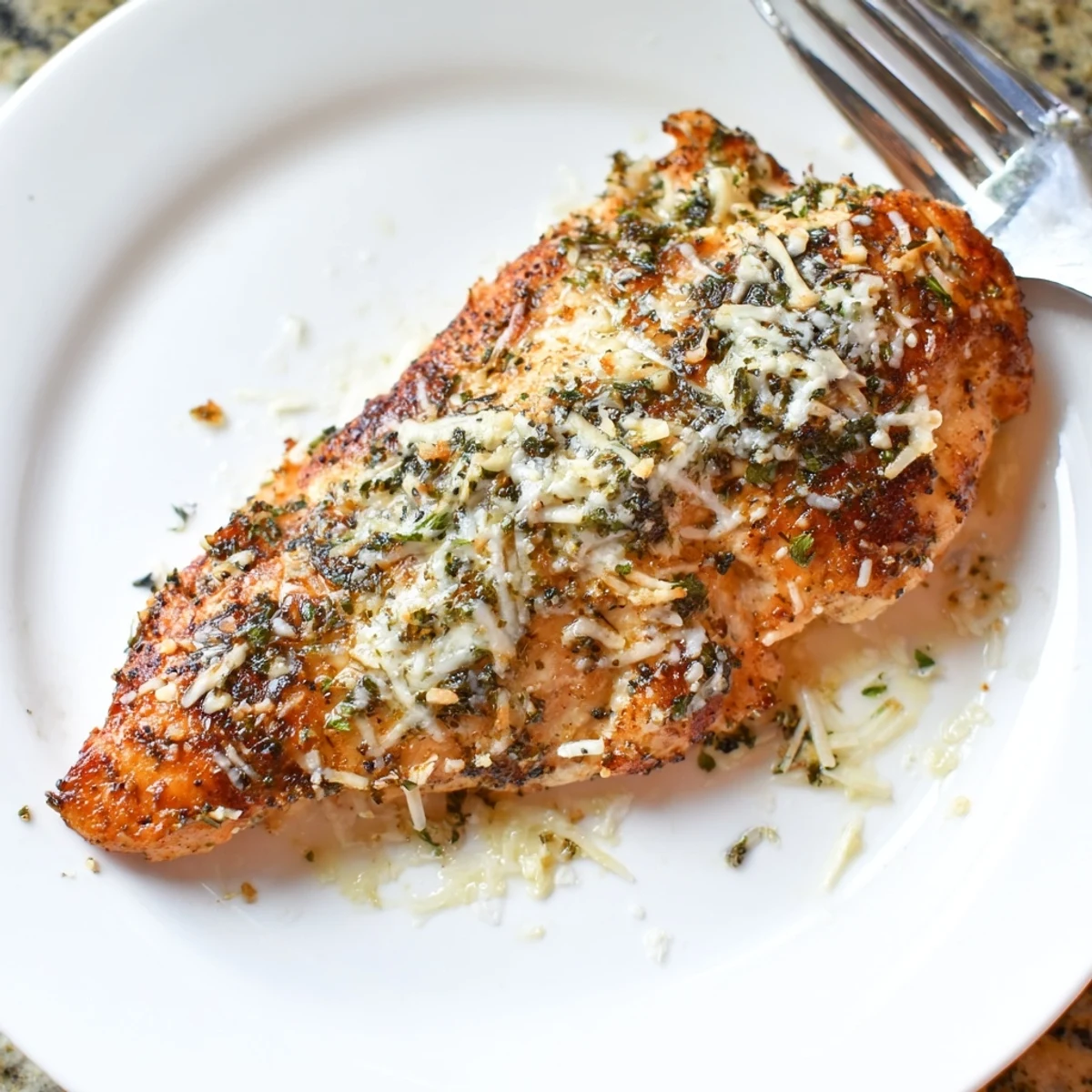 Sliced Longhorn Steakhouses Parmesan Crusted Chicken on plate, creamy cheese crust visible.