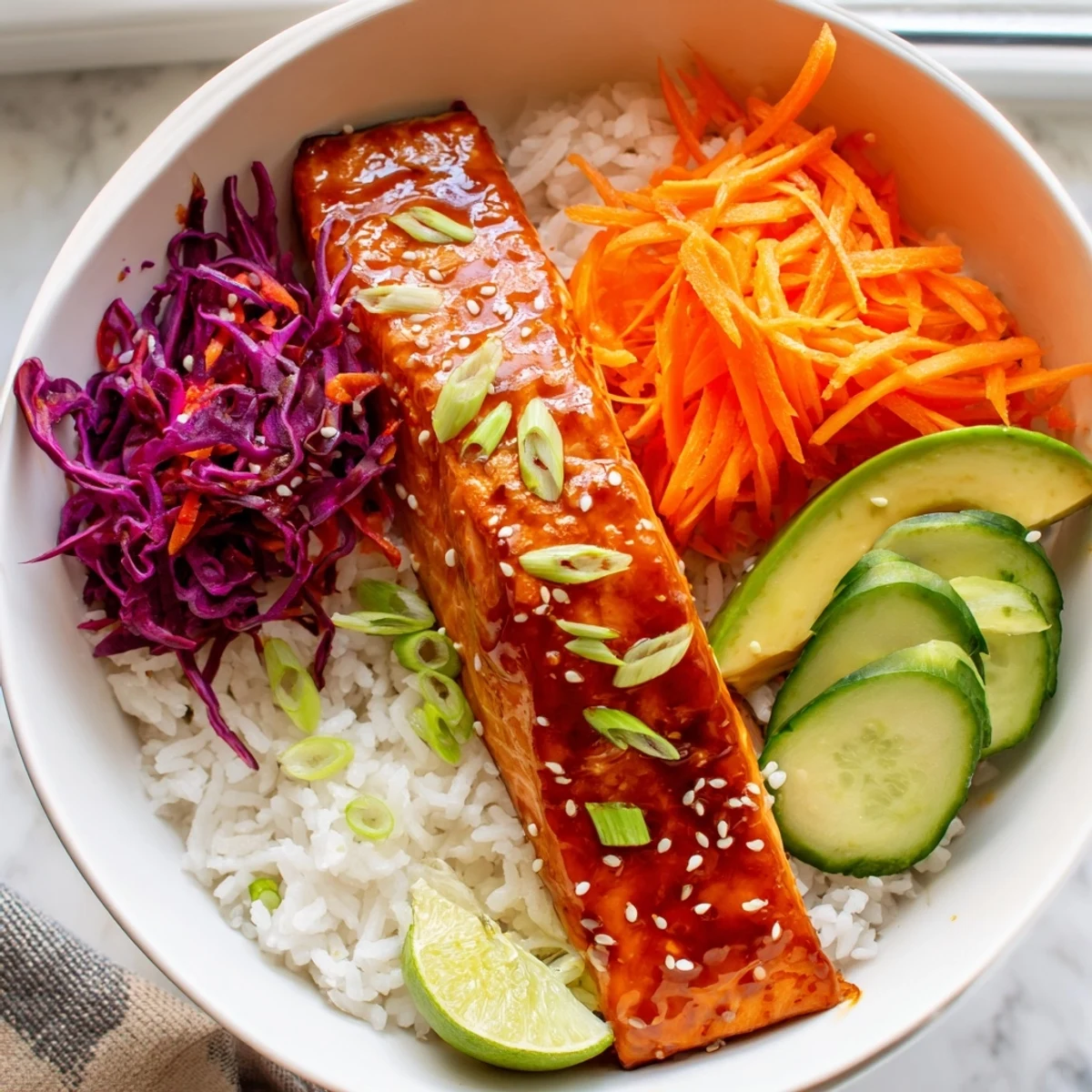 Caramelized sriracha honey glazed salmon bowls with vivid rainbow vegetables over jasmine rice
