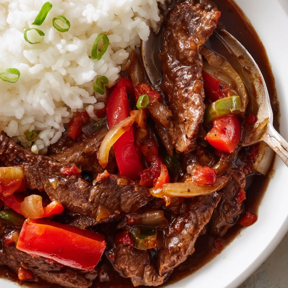 Slow Cooker Pepper Steak featuring melt-in-your-mouth beef and vibrant red and green peppers simmered together