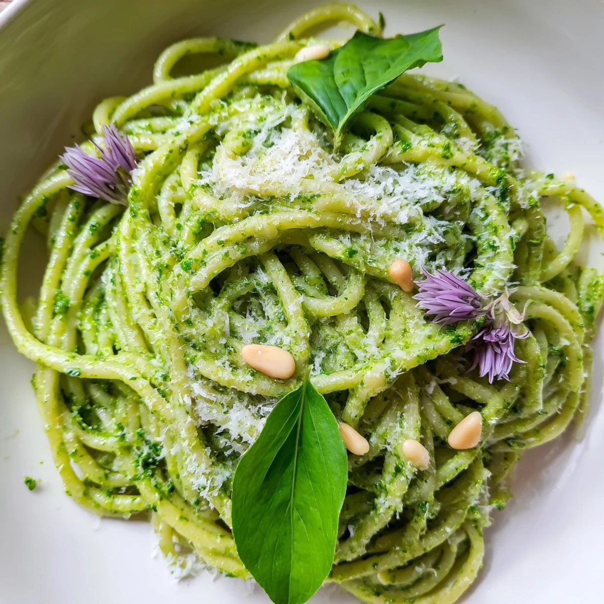 Creamy wild garlic pesto pasta served in a rustic bowl topped with pine nuts