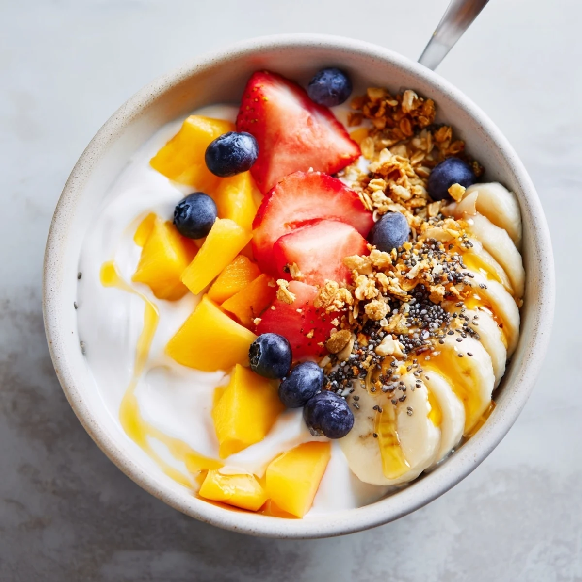 Creamy Greek yogurt serves as the base for this colorful yogurt fruit bowl recipe loaded with fresh seasonal fruits