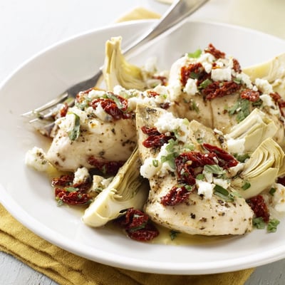 Mediterranean-style chicken breasts with artichoke hearts and crumbled feta cheese bubbling under the broiler