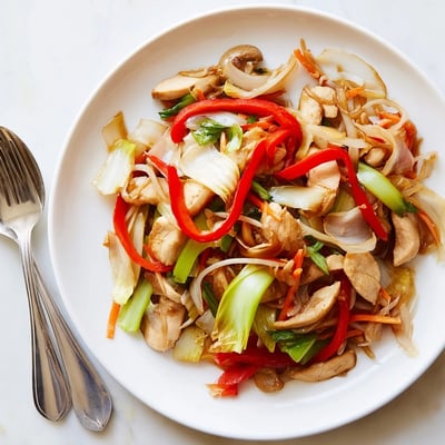 Steamy plate of Chinese-American Chop Suey loaded with bean sprouts cabbage bell peppers and juicy meat