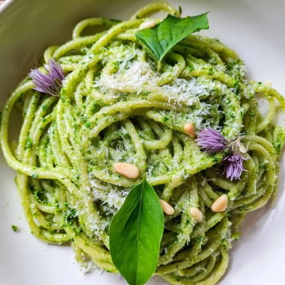 Creamy wild garlic pesto pasta served in a rustic bowl topped with pine nuts