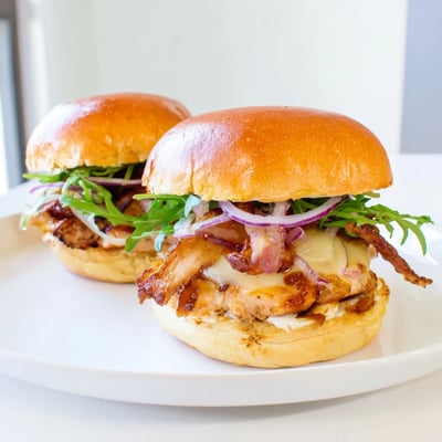 Savory Maple Chicken Bacon Sliders recipe featuring glazed meat and fresh greens on toasted buns.